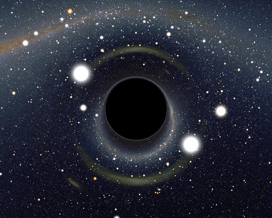 Mitten in einer sterngesprenkelten Gegend öffnet sich ein schwarzer Kreis, der wie von einem Wulst umgeben wirkt.