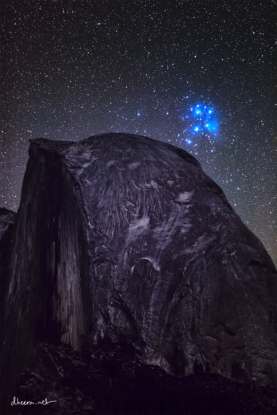 Über dem Half Dome im Yosemite-Nationalpark leuchten die Plejaden. Es ist ein kompakter Sternhaufen mit einem leuchtend blauen Nebel. Weil zufällig auch ein großer Stromausfall war, ist der Himmel ungewöhnlich dunkel.